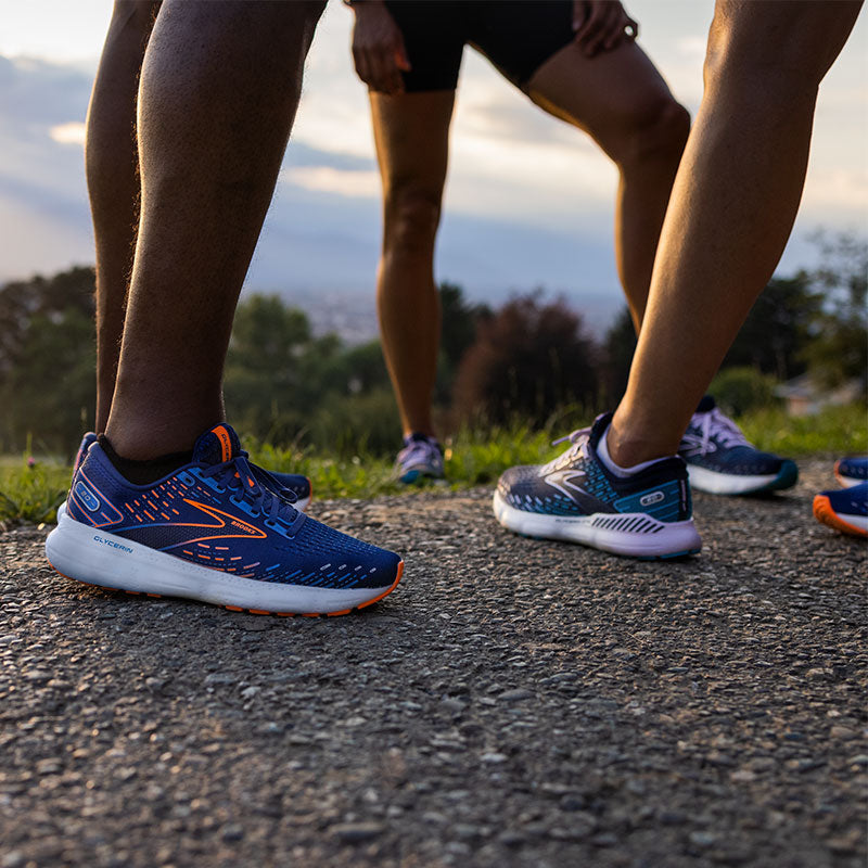 Lifestyle image: People standing on the side of a road wearing Brooks Glycerin 20 running shoes.